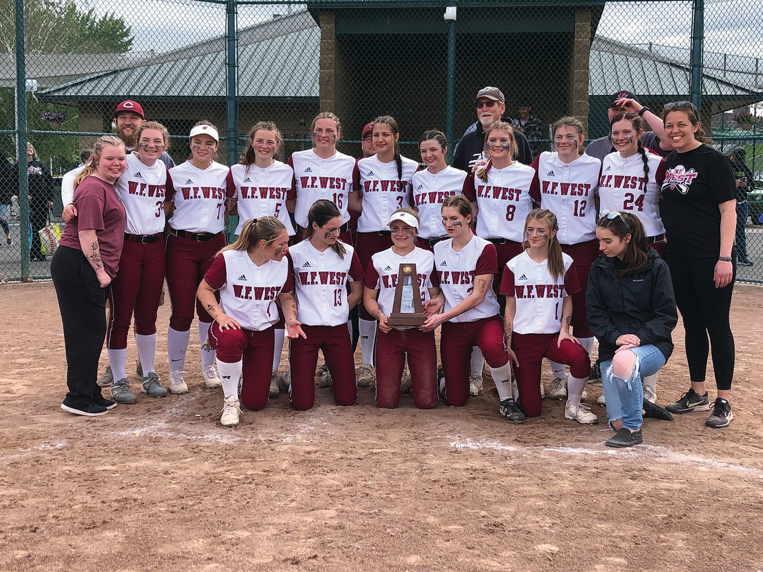 Aaron VanTuyl / For The Chronicle.W.F. West players and coaches pose with the third-place trophy at the 2A state softball tournament Saturday afternoon at Carlon Park in Selah.